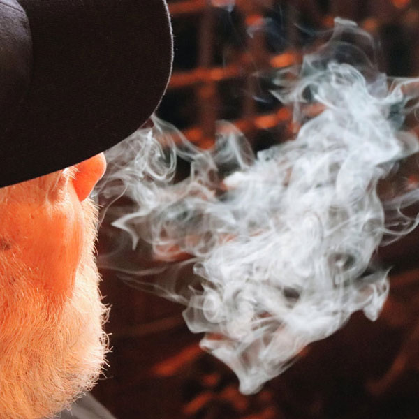 ash-and-anvil-cigar-lounge-downtown-gardner-ks-customer-enjoying-a-smooth-cigar